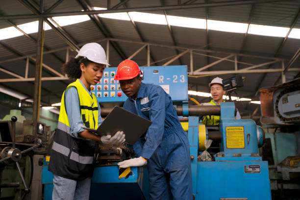 istock Blue collar workers work at machinery factory. 1662923371