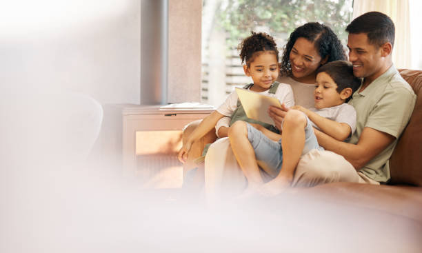 istock Family, children and tablet on sofa in e learning, video streaming and school or online education with parents love and support. Happy mother, father and kids on couch, digital tech and home mockup 1662925462
