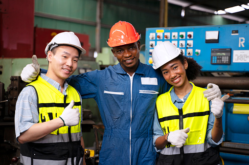 Blue collar workers work at machinery factory. Engineering and blue collar worker concept.