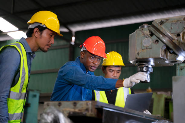 istock Blue collar workers work at machinery factory. 1662926555