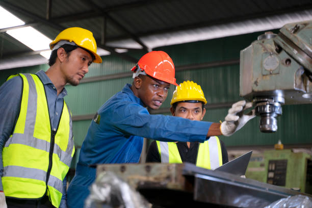 istock Blue collar workers work at machinery factory. 1662927070