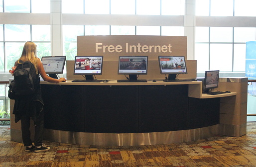 Singapore City - February 2, 2022 - Visitors use the free computer and internet facilities provided at Changi Airport, Singapore City.