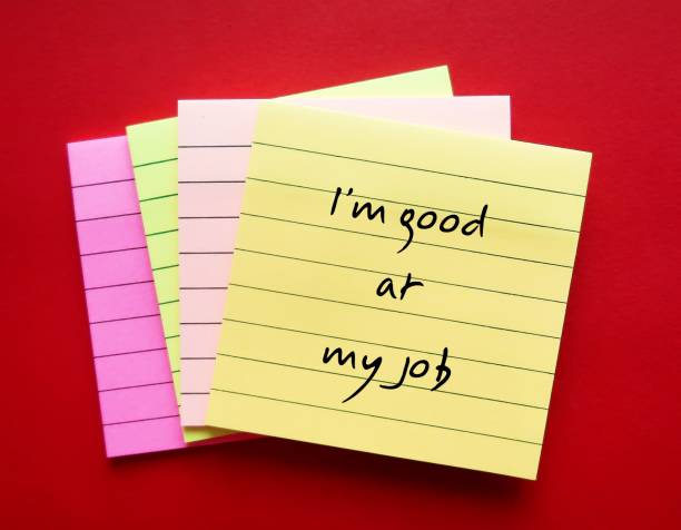 istock Office note pad on red background with handwriting - I am good at my job - positive self talk affirmation for self motivation at work 1662936450