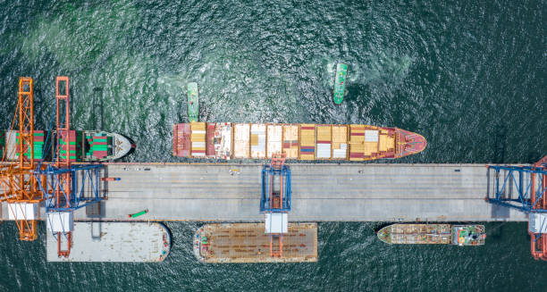 istock Tug boat pull cargo container ship to cargo shipyard sea port. Container Ship at international customs freight export import . 1662943095