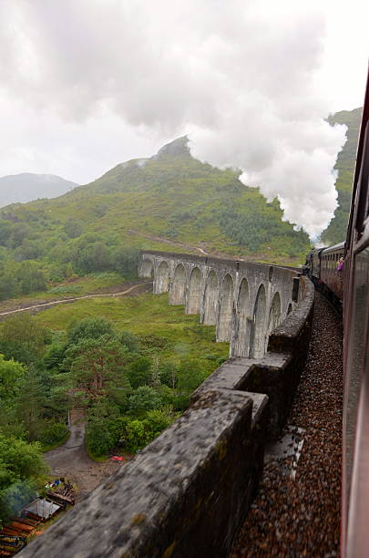 Jacobite steam train crossing Glenfinnan viaduct. stock photo