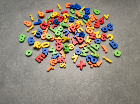 Heap of colorful alphabet letters and numbers. Education concepts