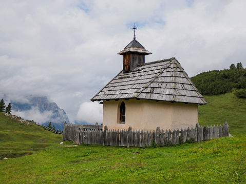 small church in monte croce cross mountain in dolomites badia valley panorama landscape