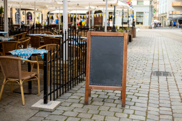 Restaurant sidewalk chalkboard sign board. Old Blak Signboard on the street. Blank signage sign design mockup isolated
