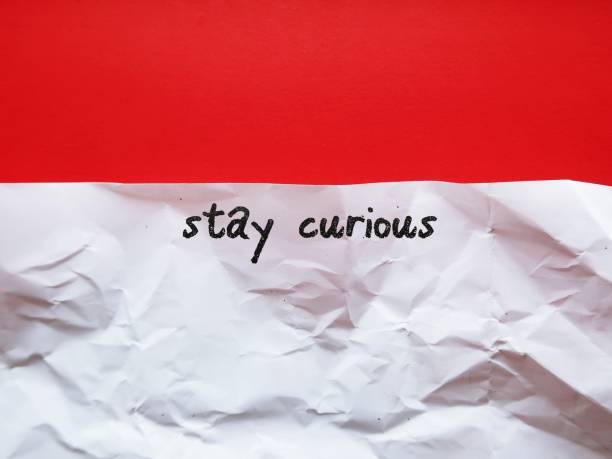istock Crumpled paper on red background with handwritten text STAY CURIOUS, to remind us to stay curious as we grow older, improve our learning mechanism, rekindling the desire to know more 1663009018