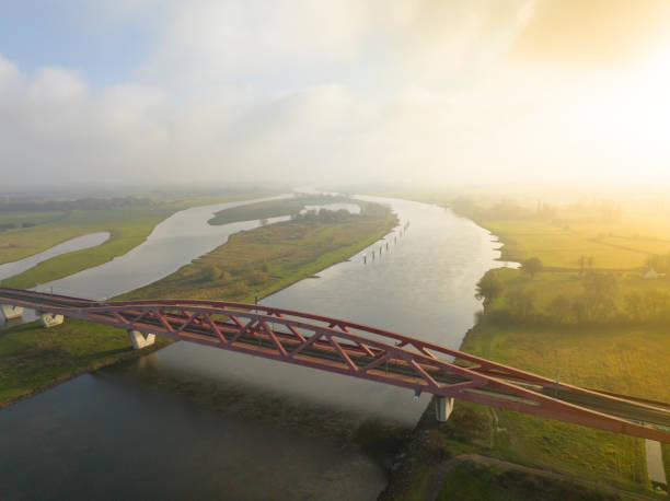istock Hanzeboog train bridge over the river IJssel from above 1663010336