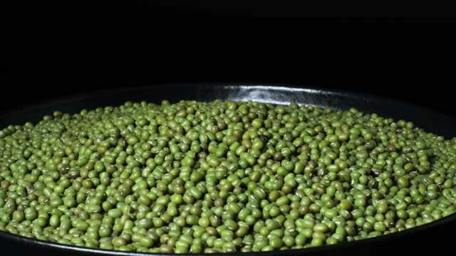 Organic natural dried green mung beans rotating on a plate