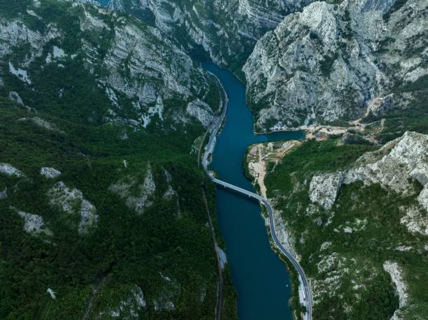 istock Aerial view of a river flowing through green mountains 1663039999