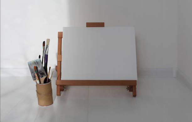 istock Empty copy space canwas on wood easel and paintbrush in artistic workshop interior 1663046586