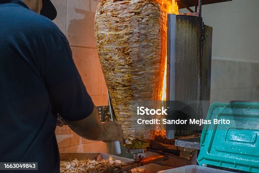 istock Meat trompo for tacos al pastor. Mexican street food. Marinated meat al pastor. 1663049843
