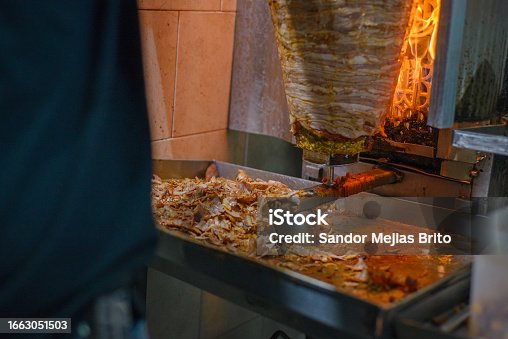 istock Meat trompo for tacos al pastor. Mexican street food. Marinated meat al pastor. 1663051503