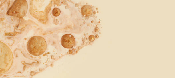istock Macro Gold bubble drops in oil. Abstract flow color blots horizontal background. 1663058801