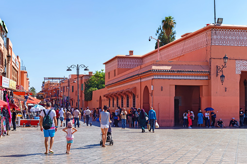 Marrakesh, Morocco - June 03, 2017: View of the typical red walls historic buildings in the center of Marrakech on a sunny day