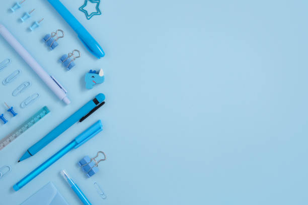istock Frame of blue school and office stationery set on light blue background. 1663065501