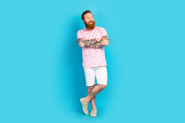 istock Full length photo of creative minded person folded hands look interested empty space ad isolated on blue color background 1663069335