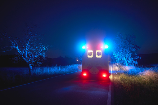 Hospital health care and medicine. Ambulance and emergency.\nGroup of medical workers transferring a patient from the hospital gurney to the stretcher