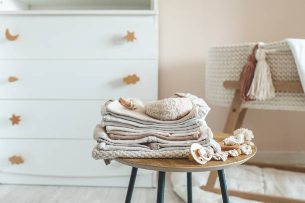 istock A stack of children's things on a wooden table in a children's interior 1663093722