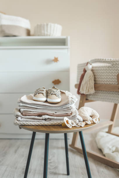 istock A stack of children's things on a wooden table in a children's interior 1663093723