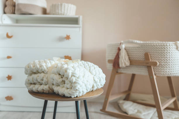istock Handmade knitted blanket for a newborn in a nursery 1663093759