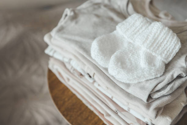 istock A stack of baby clothes and knitted socks for a baby 1663103781