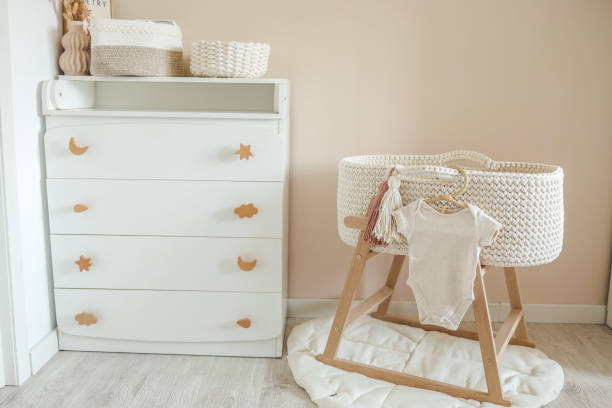 istock Children's beige bodysuit on a wooden hanger in the nursery 1663104320