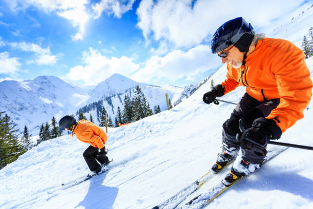 senior couple skiing stock photo