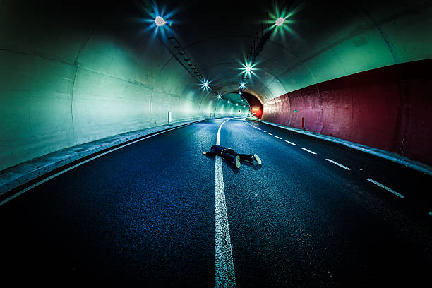 Dead Man in the Tunnel, Roadkill Dead man lying down in the middle of the road middle of the road stock pictures, royalty-free photos & images