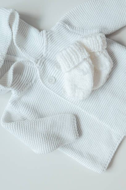 istock Knitted children's socks and handmade sweater 1663110303