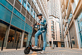 Full body Young woman in shirt and helmet with electric scooter at the city  People lifestyle concept