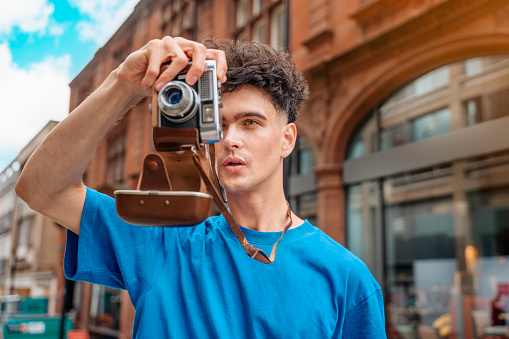 man in blue shirt    walking around  city, taking photos, selfie, having fun as tourist Lifestyle concept