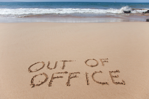 Out of office. A simple concept image written in the sand on a beautiful Hawaii beach.