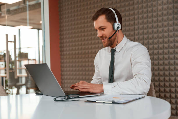 istock Using laptop. Handsome man in formal clothes is in the office 1663127123