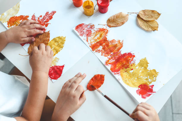 istock Children color the leaves and make a print, autumn creativity 1663128839