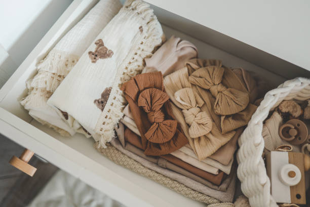 istock Dresser with clothes for a newborn, organizing storage 1663132741