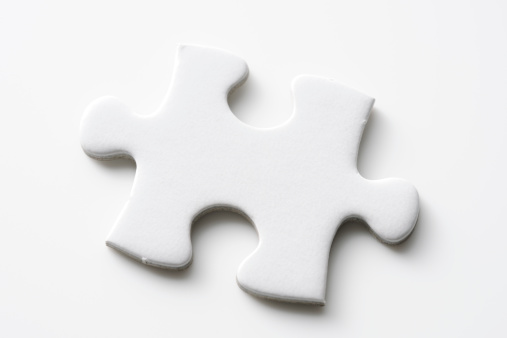 Isolated shot of blank jigsaw puzzles piece on white background
