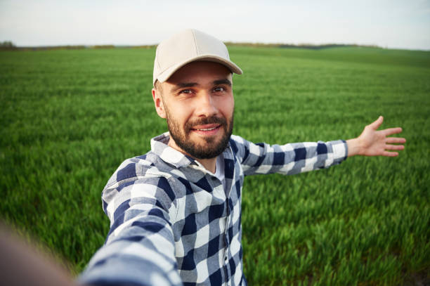 istock Making selfie. Handsome young man is on agricultural field 1663148209