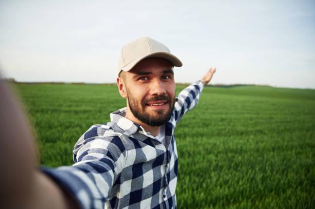 istock Making selfie. Handsome young man is on agricultural field 1663148210