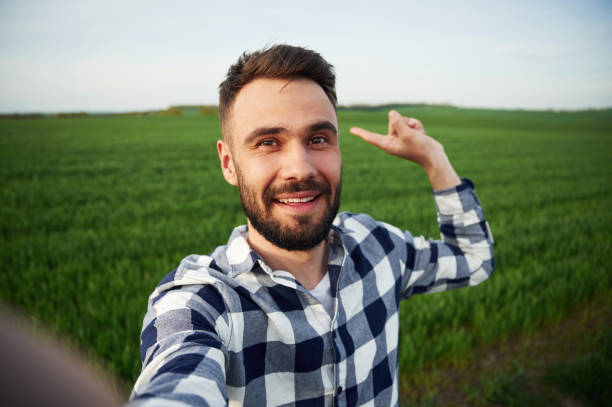 istock Making selfie. Handsome young man is on agricultural field 1663148226