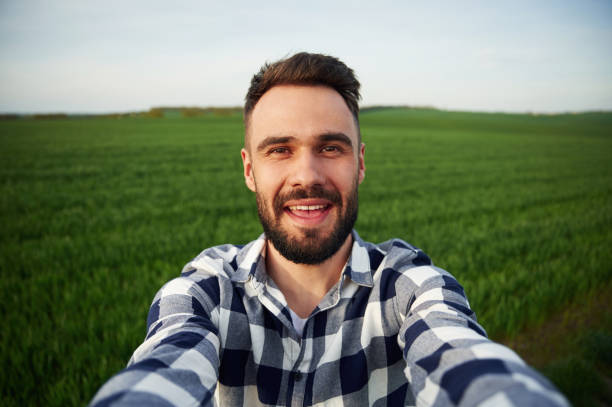 istock Making selfie. Handsome young man is on agricultural field 1663148229