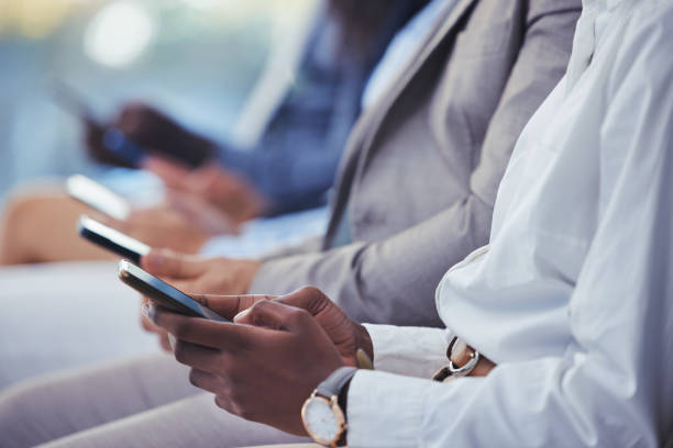 istock Hands, phone and human resources with a group of people waiting in line for an interview or meeting. Mobile, hiring and recruitment with business collegues sitting in an hr candidate shortlist row 1663148815