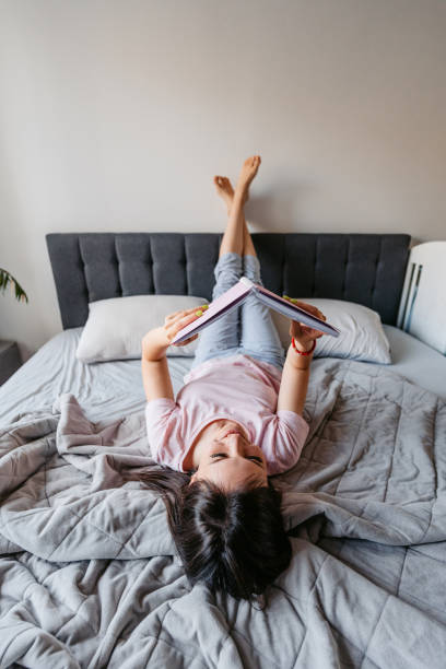 istock Young Woman Reading From Her Notebook In The Bed In The Morning 1663152281
