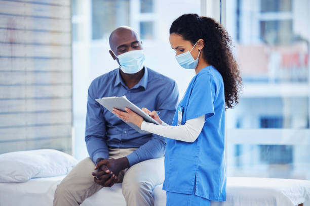 Doctor consultation, mask and patient results of a nurse with a black man in a hospital. Clinic, covid conversation and nursing communication with medical data and healthcare discussion for advice consulta médica, mascarilla y resultados del paciente de una enfermera con un hombre negro en un hospital. clínica, conversación covid y comunicación de enfermería con datos médicos y discusión de atención médica para obtener asesoramiento