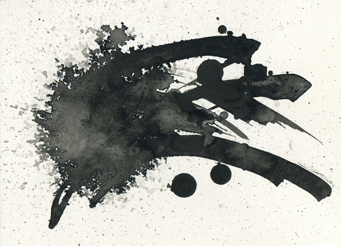 Abstract Black ink blot on paper texture copy space bakground.