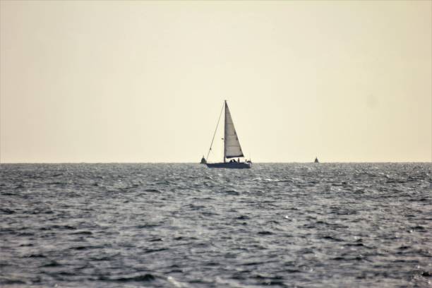 Yacht Sailing along the horizon on calm waters