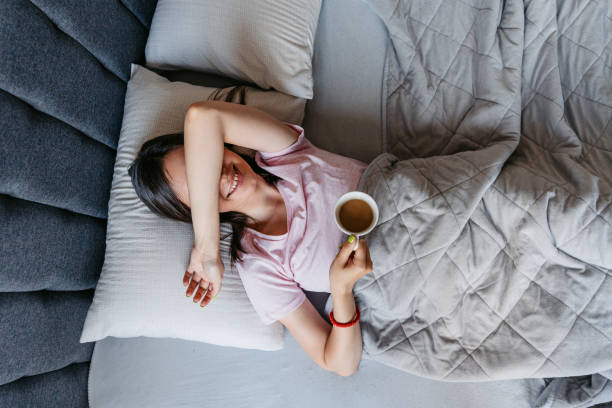 istock Young Woman Drinking Coffee In The Bed In The Morning 1663162802
