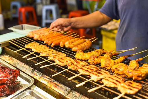 Grilled chicken meat and sausages bbq in Jalan Alor street food in Kuala Lumpur